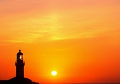 lighthouse and com antenna in glorious sunset