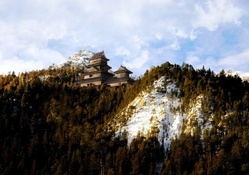 japanese castle on a mountain in winter