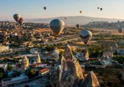 hot air balloons over a turkish town