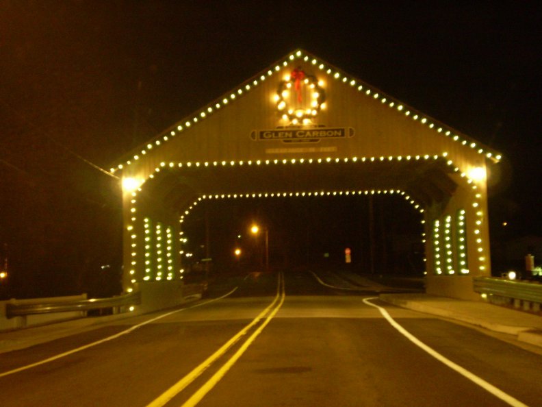 A covered bridge lighted up