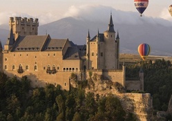 hot air balloons over a castle