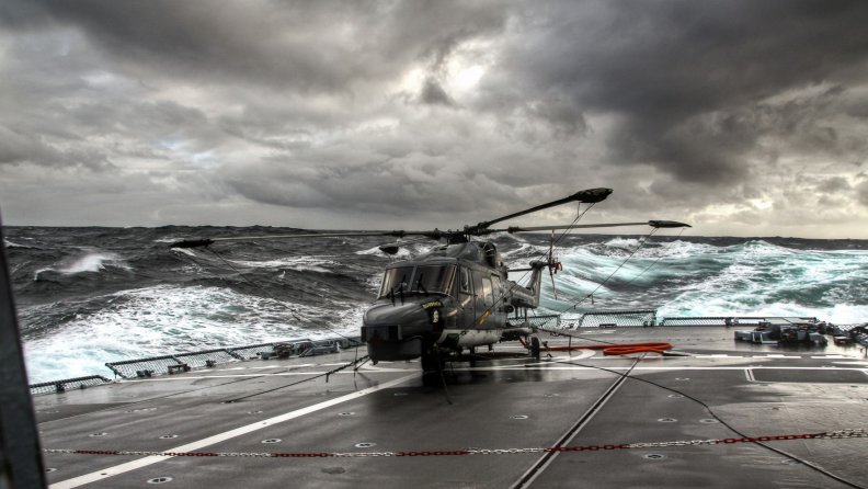 helicopter on a carrier in rough seas