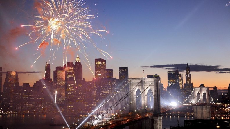 fireworks and lights over brooklyn bridge