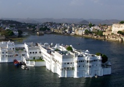 white house in the middle of a river in india