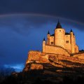 rainbow over castle on a cliff