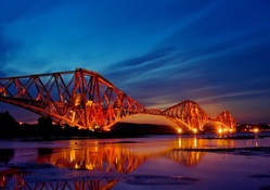 the firth of forth bridge in scotland at night