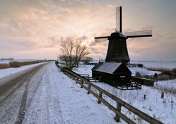 windmill by a winter country road