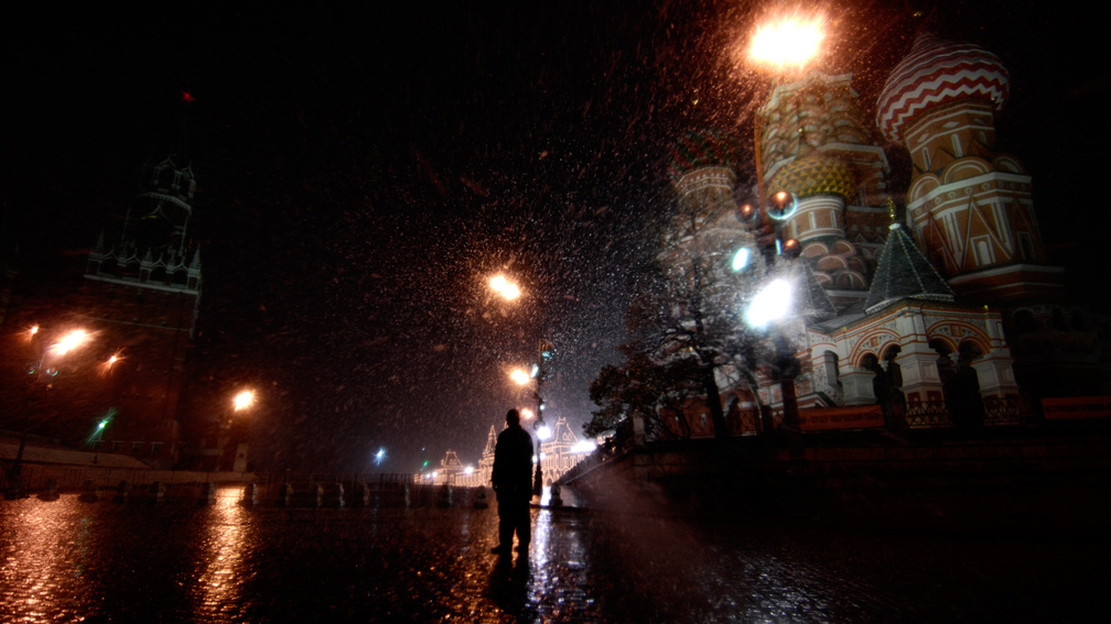 snow shower in red square moscow at night