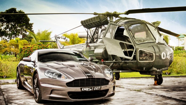 an aston martin dbs next to a helicopter hdr