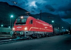 commercial train pulling out at night