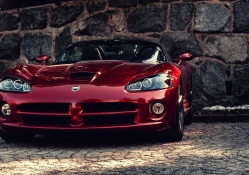 dodge viper parked at a stone wall