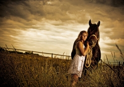 GIRL AND HORSE AT SUNSET RESTING