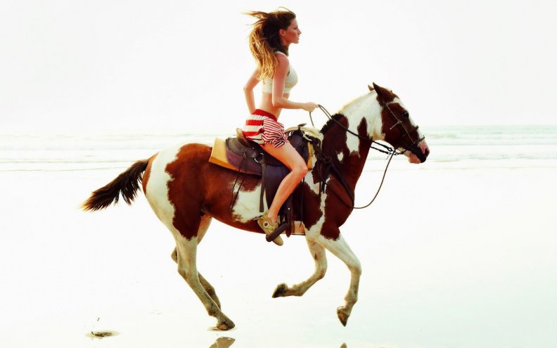 cowgirl_riding_the_beach.jpg