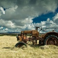 old rusty tractor in hay field