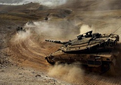 column of israeli merkava tanks in the desert