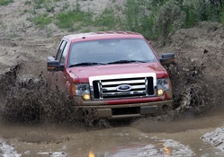 FORD DRIVING DEEP IN THE MUD