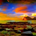 colorful sky over rocky seashore