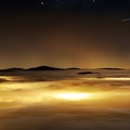 starry sky over a sea of clouds
