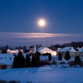 december moon over suburban landscape in winter