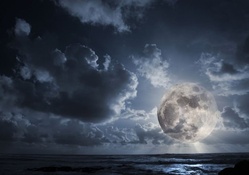 huge full moon over the ocean