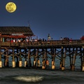 moon over tiki bar on a pier