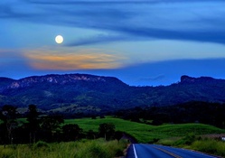 highway to mountains under moonlight