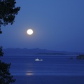 moon over boat in straits