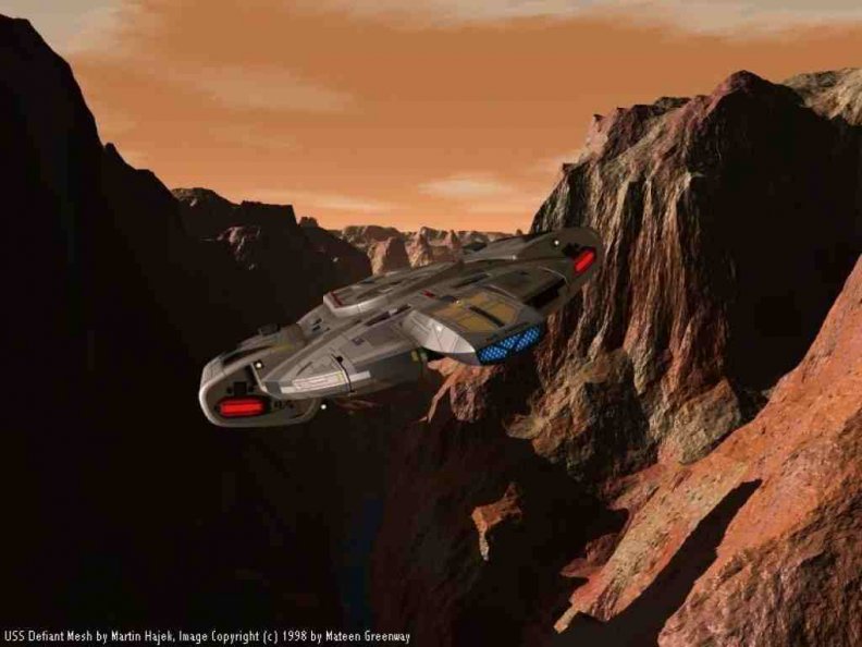 USS Defiant flying though canyon