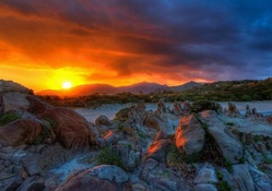 superb sunset over rocky shore hdr