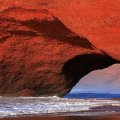 Red rock arch on beach in Phillipines