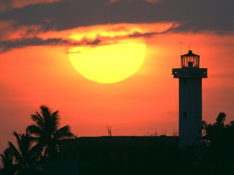 sunset_over_lighthouse_and_trees.jpg