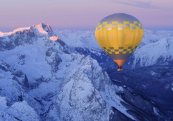 Hot Air Balloon over Snow_Covered Mountains