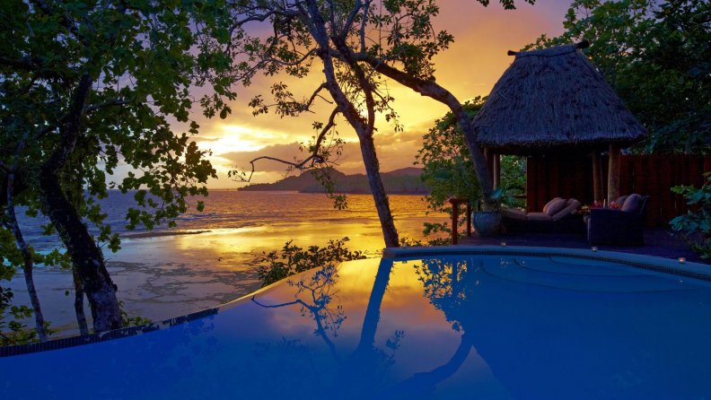perfect_sunset_over_a_seaside_resort_pool.jpg