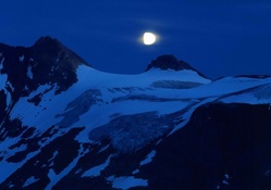 Moon over Snow_covered Mountains