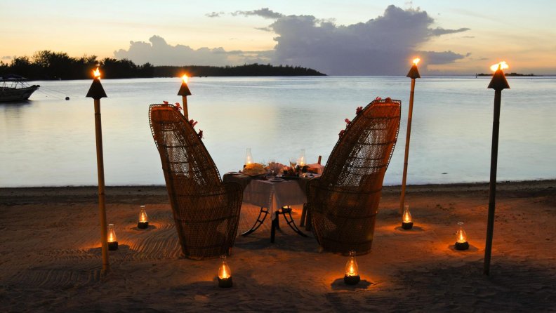 candlelight table for two at sunset in bora bora
