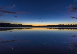 moon over lake at dusk