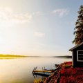 bright sunrise on a little lakehouse in autumn