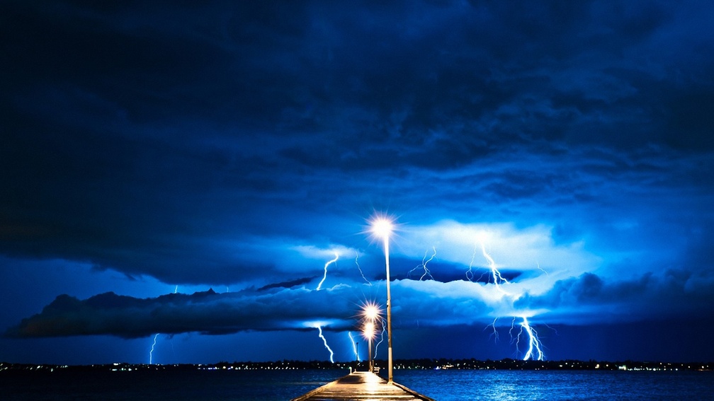 lightning storm from a pier at night