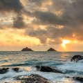 sunrise off a rocky hawaiian seashore