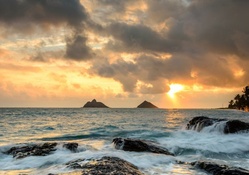 sunrise off a rocky hawaiian seashore