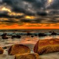 marvelous sunset on a rock strewn beach hdr