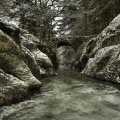 stone bridge over river gorge in winter monochrome 
