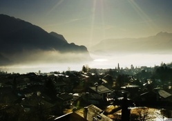 sun rays over a valley town