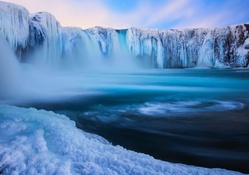 magnificent iclandic waterfall in winter