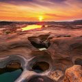 amazing rocky pools under a sunset