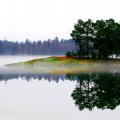 colorful rocky shore on a misty lake