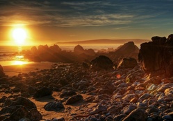 wondrous sunset over rocky shore hdr