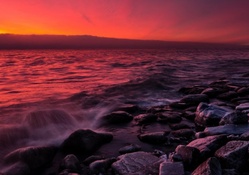red sunset on a rocky shore