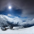 panoramic view of mountain top cabins in winter