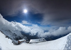 panoramic view of mountain top cabins in winter